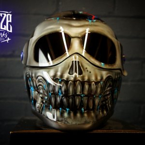 Chrome skull motorcycle helmet with metallic silver finish, detailed teeth and jaw, dark eye sockets, professional airbrush work